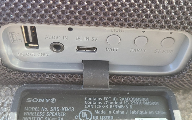 The input ports are located on the rear of the speaker.