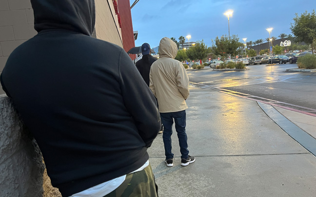 Standing in line during rainfall in order to secure a Nintendo Switch OLED